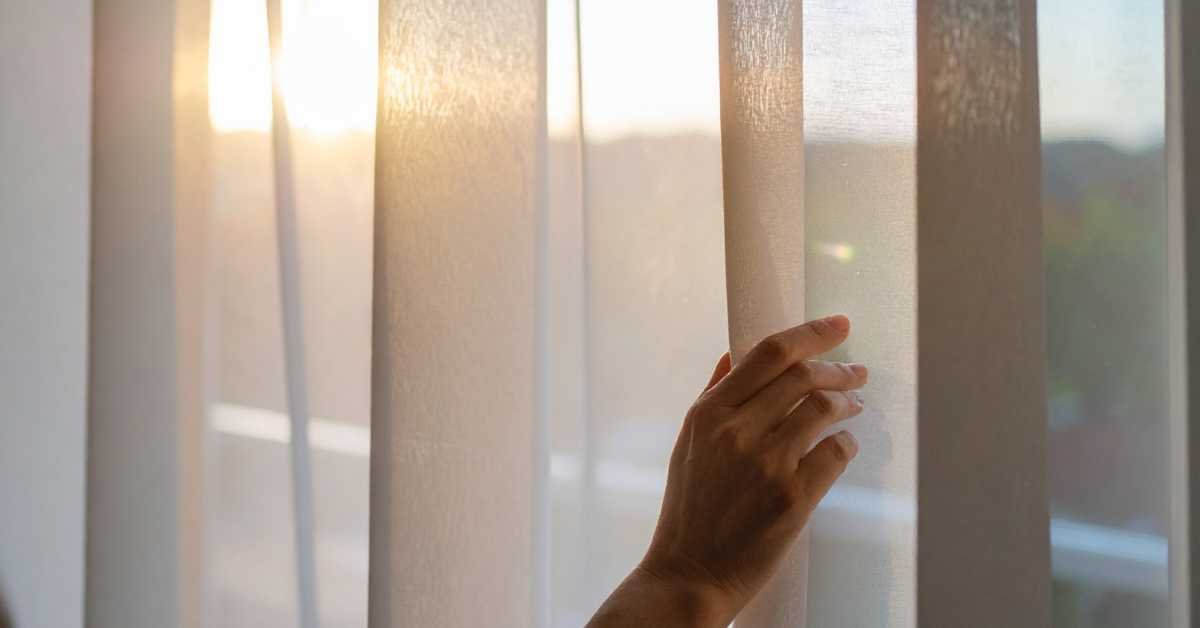 hand checking warm balcony sunlight