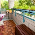 small apartment balcony with many plants but open walking space